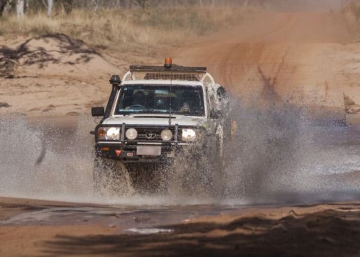 4wd crossing a creek in the outback