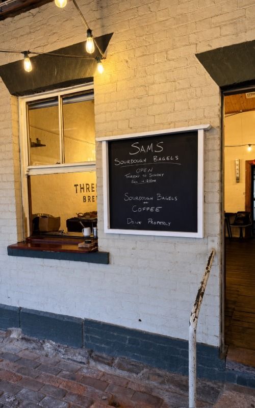 The inviting white brick shopfront of Sam's Bagels in Mudgee, New South Wales
